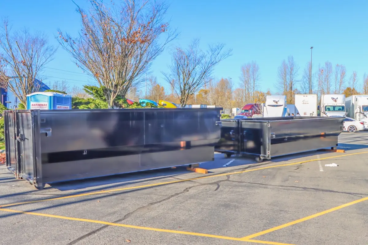 Professional dumpster rental service with roll-off container on residential driveway in North Royalton